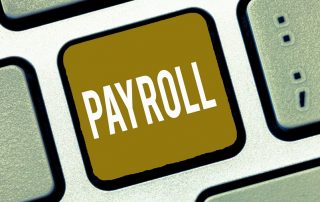 Minimum wage increase effects image shows closeup of keyboard. One key has gold background with white text "PAYROLL".