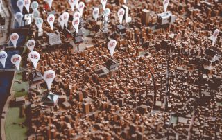 Opening a new frozen custard store image shows city landscape with pins with letter/number combo on them. Indicating a map.