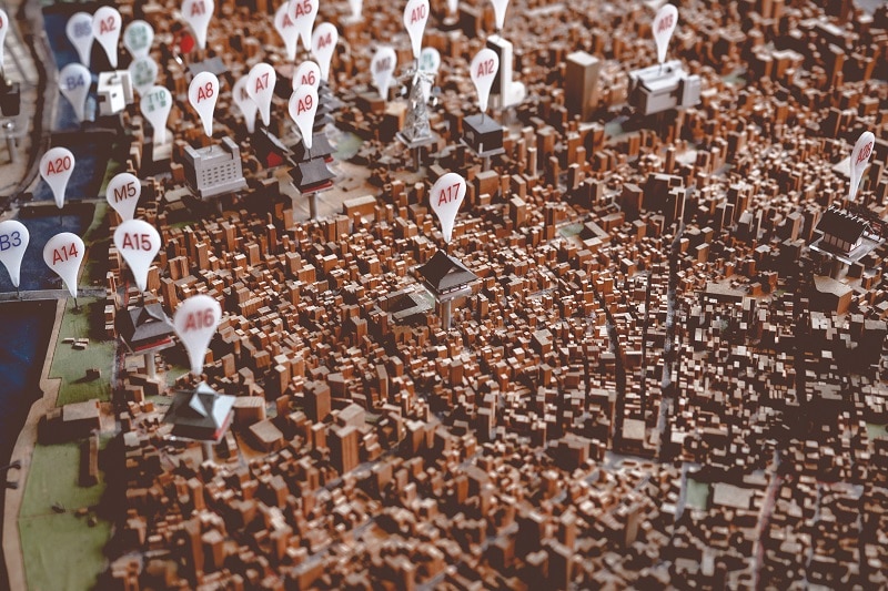 Opening a new frozen custard store image shows city landscape with pins with letter/number combo on them. Indicating a map.