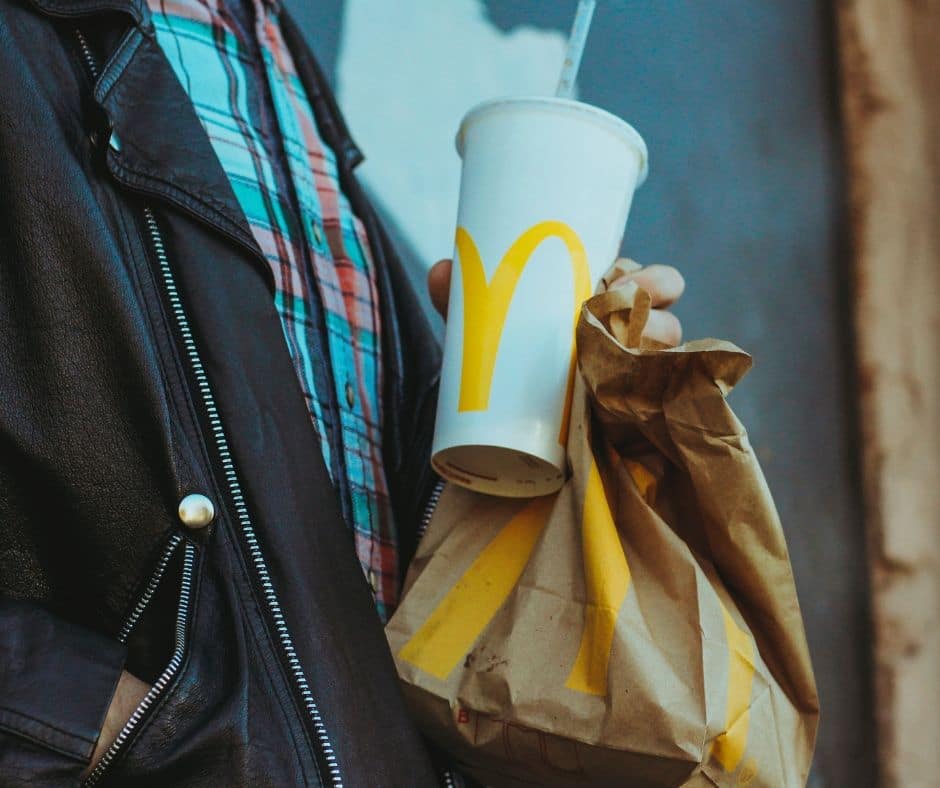 Opening a new frozen custard store image shows fast food beverage cup & bag. It has the McDonald branding double arch on them.