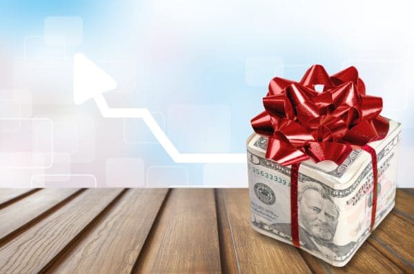 Christmas present with red bow wrapped in dollar banknotes Sorry we are closed